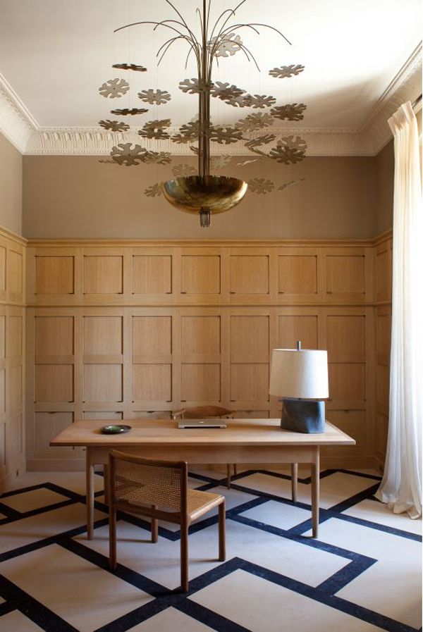 A wood paneled office, complete with graphic floor pattern, in a Château in Provence. Design by Pierre Yovanovitch.