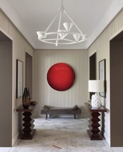 A red circle painting creates a stunning entrance focal point at the end of the hall
