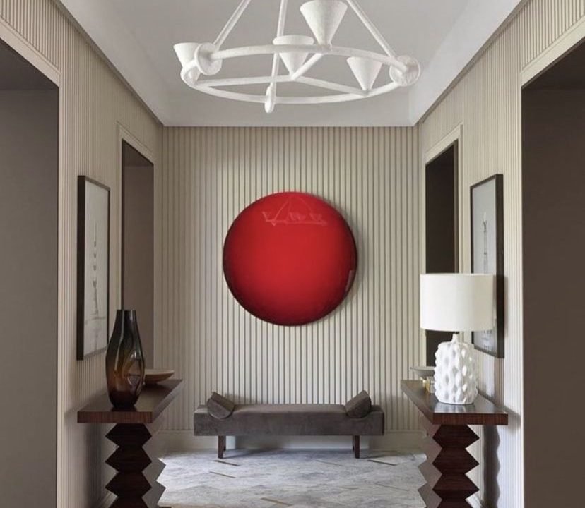 A red circle painting creates a stunning entrance focal point at the end of the hall