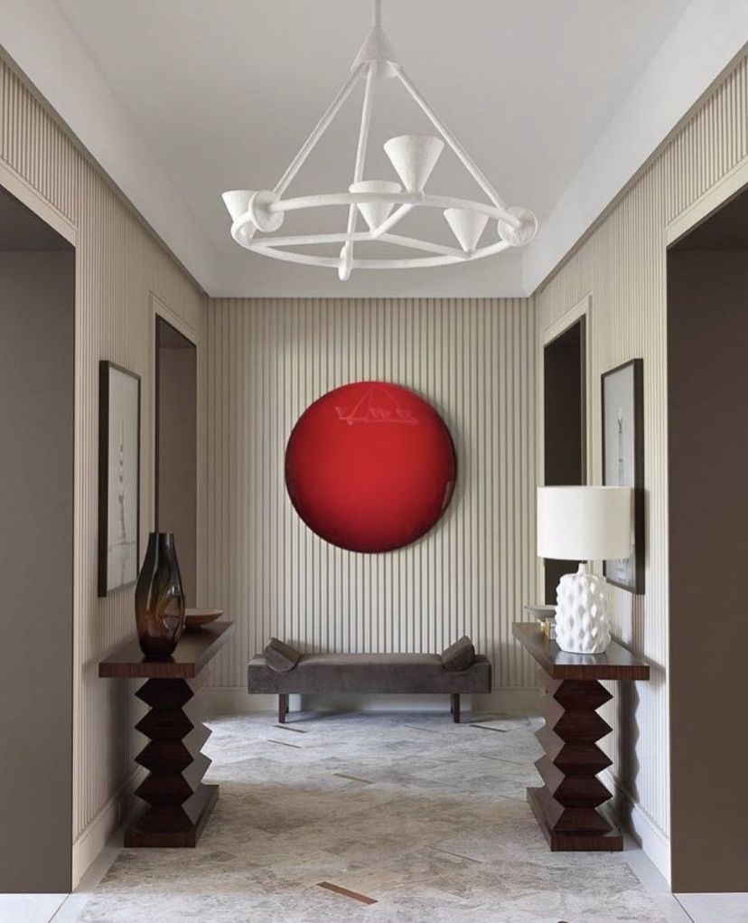 A red circle painting creates a stunning entrance focal point at the end of the hall