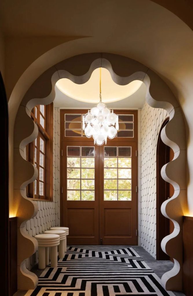 Brightly lit entrance way with a bespoke wave curve across the doorway